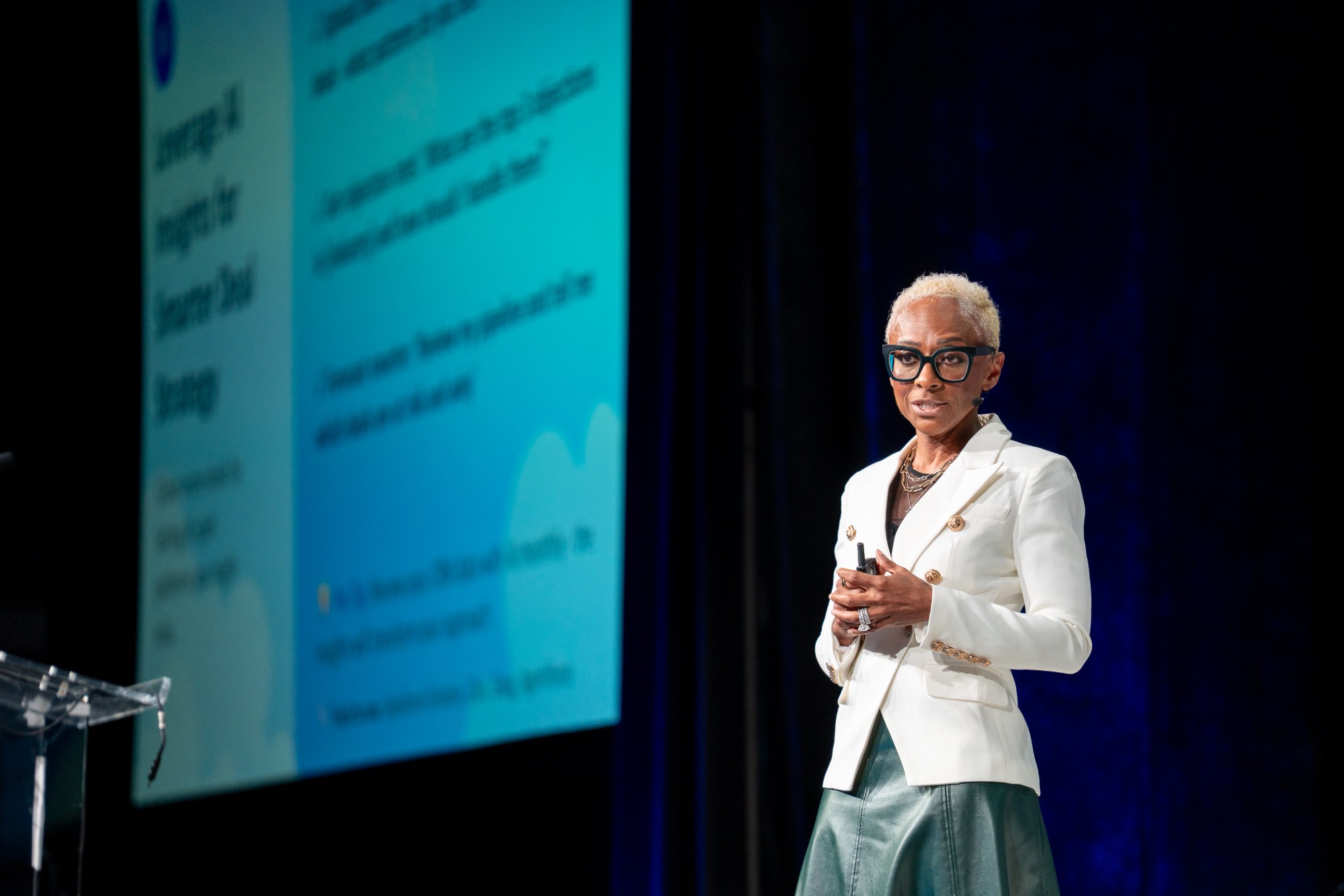 A speaker presents on stage at HealthStack Conference